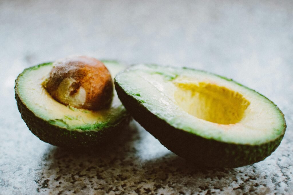 Close-up of a halved avocados, showcasing its rich texture and vibrant green color.