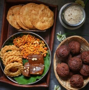 An assortment of delicious Indian snacks and sweets served in a rustic setting with tea.